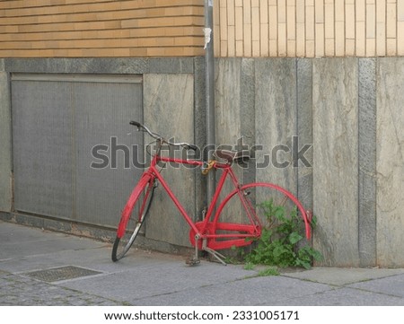 red bicycle abandoned on a street corner. High quality photo
