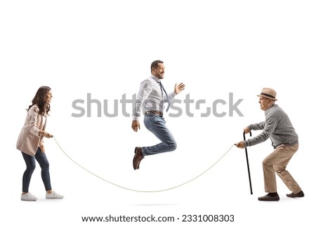 Young man and woman playing skipping rope with an elderly man isolated on white background Royalty-Free Stock Photo #2331008303