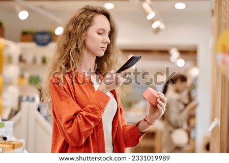 Customer making photo of cream on smartphone