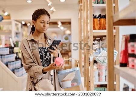 Woman making photo of cream