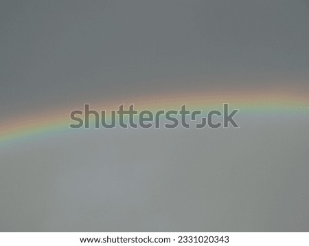 Picture a beautiful rainbow in the afternoon.