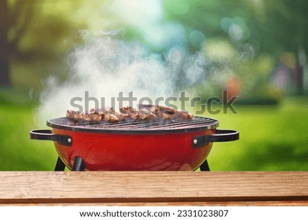 summer time party in backyard garden with grill BBQ, wooden table, blurred background Royalty-Free Stock Photo #2331023807