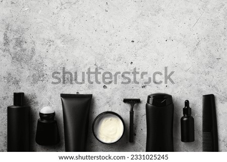 Premium men's grooming products, beauty and personal care concept. Flat lay black shampoo bottle, shower gel tube, deodorant, moisturizer cream, razor, serum, hair comb. Royalty-Free Stock Photo #2331025245