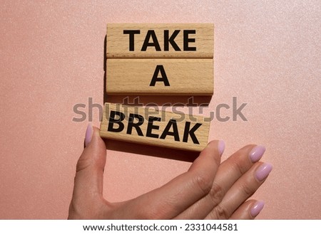 Take a break symbol. Concept words Take a break on wooden blocks. Beautiful pink background. Businessman hand. Business and Take a break concept. Copy space.