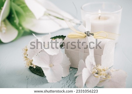 Confirmation or First holy communion concept  - small present with candle and flowers Royalty-Free Stock Photo #2331056223