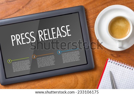 Tablet on a desk - Press Release Royalty-Free Stock Photo #233106175