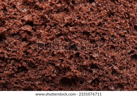 Tasty chocolate sponge cake as background, closeup Royalty-Free Stock Photo #2331076711