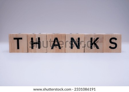 Wooden block writing message "THANKS"