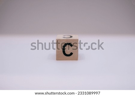 Wooden block written "C" with a white background