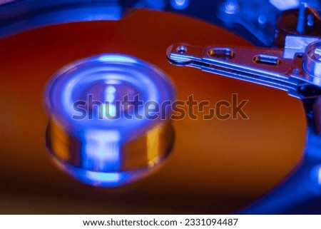 Computer hard drive without protective cover. Close up of hard disk with abstract reflection. Opened hard drive from the computer hdd with mirror effects Part of computer pc. Soft selective focus