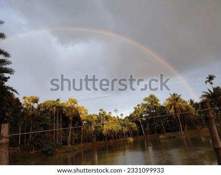 A rainbow over a body of sky awesome picture