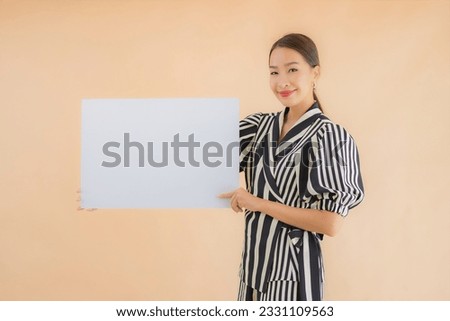 Portrait beautiful young asian woman show empty white billboard paper for text and copy space