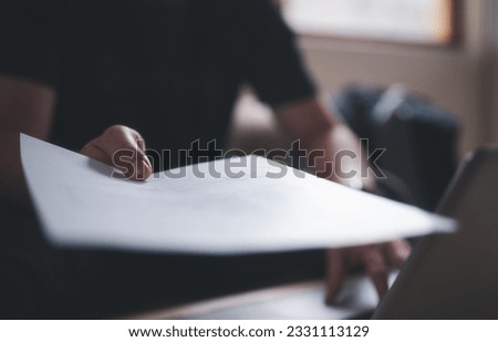 man hand holding or handing over document, documentation, document data management system Royalty-Free Stock Photo #2331113129