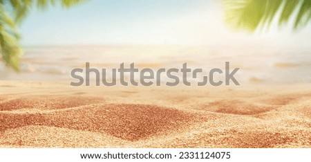 Beautiful background for summer vacation and travel. Golden sand of tropical beach, blurry palm leaves and sea on sunny day.