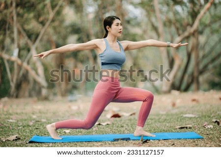 Portrait of young woman practicing yoga in garden.female happiness.  in the park blurred background. Healthy lifestyle and relaxation concept in sun light
