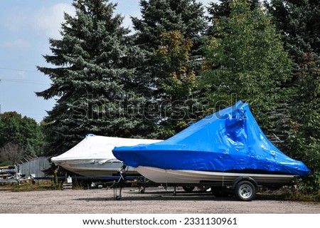 Shrink wrapped boats ready for winter Royalty-Free Stock Photo #2331130961