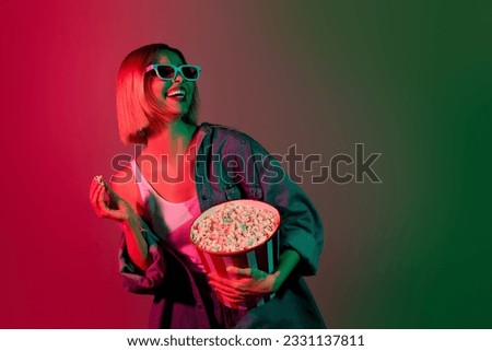 Photo of positive girl look empty space ready for new movies in cinema with 3d goggles watching isolated colorful neon background