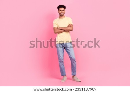Full length photo of satisfied pleasant friendly guy wear yellow shirt standing holding arms crossed isolated on pink color background