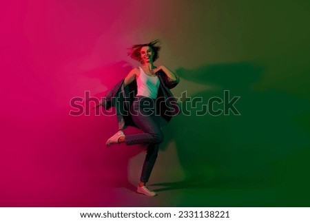 Full length photo of positive cheerful lady dancing nightclub energetic freestyle moves isolated vivid bright neon dark color background