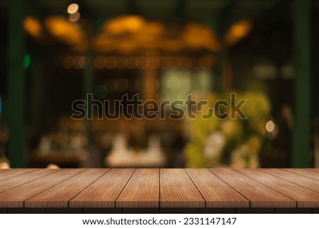 Empty wooden table top with lights bokeh on blur restaurant background.	 Royalty-Free Stock Photo #2331147147