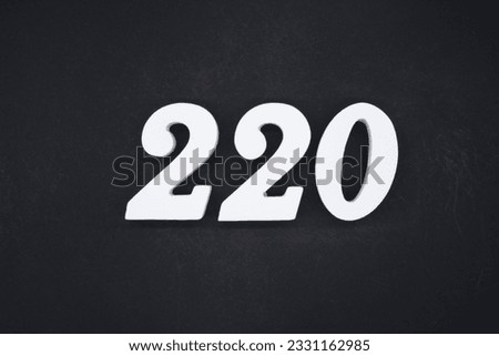 No. 220, made of white painted wood. Put it on a wooden board that is sprayed black as a background.