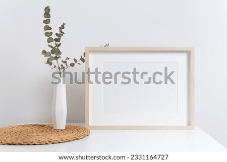Horizontal artwork frame mockup in white room interior, blank wooden frame mock up with copy space