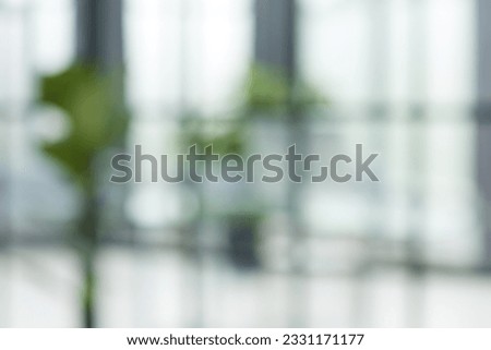 Blurred abstract grey glass wall from building background.