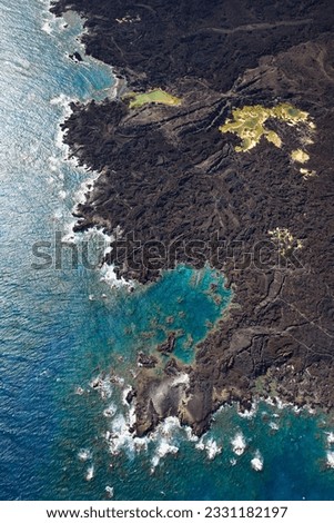 Aerial of Maui, Hawaii coastline with lava rocks.