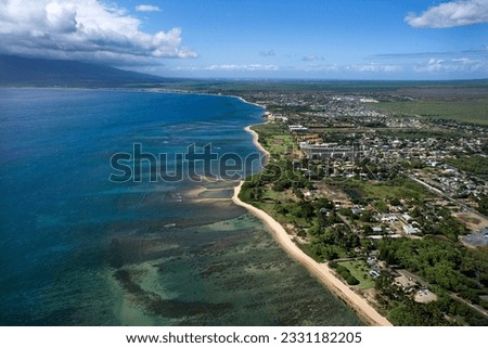 Aerial of Maui, Hawaii coastline with beach and buildings.