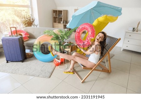 Young woman with swim ring ready for summer vacation at home