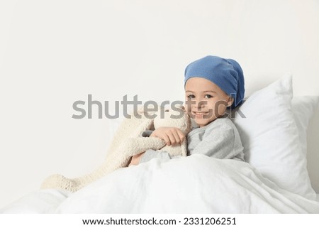 Childhood cancer. Girl with toy bunny in hospital Royalty-Free Stock Photo #2331206251