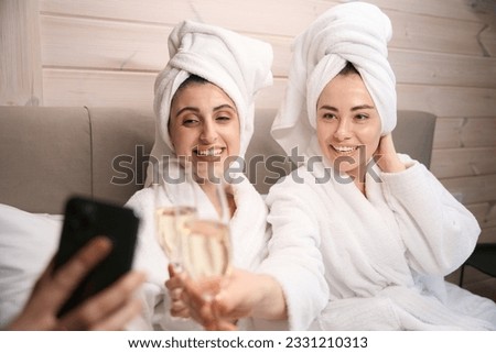 Beautiful female with her friend taking picture after spa procedures