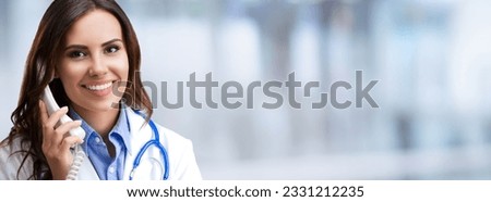 Portrait image of happy smiling female doctor on phone, on blurred modern office background. Medical call center concept picture.