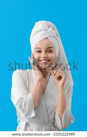 Beautiful young woman with ampule on blue background. Skin care concept