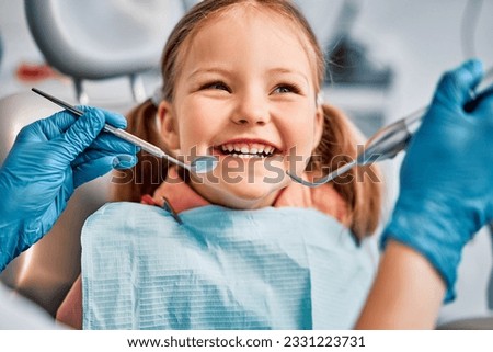 Children's dentistry. Live funny photo of a laughing child at the dentist's appointment. Royalty-Free Stock Photo #2331223731