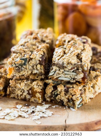 Healthy homemade granola bars and  various ingredients  on  background