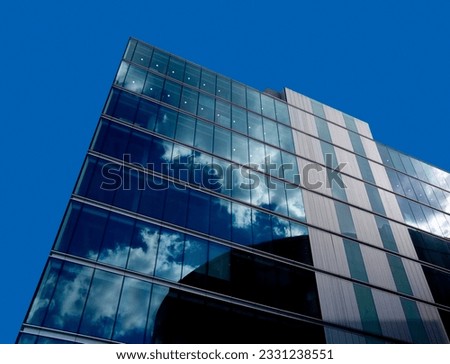 office block clouds on the inside clear blue sky outside