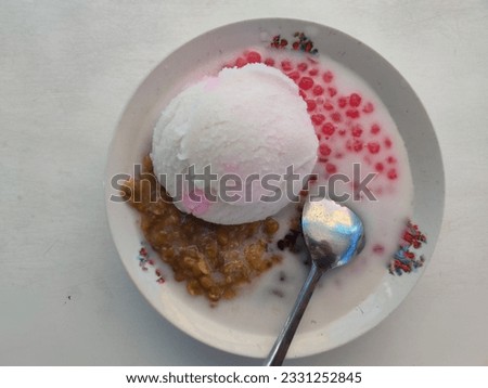 green bean porridge with ice cream topping on a white plate isolated on white background