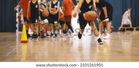 Youth Basketball Players in a Team on Training Drill. Young Boys Practice Basketball With Young Coach. Basketball Training Unit For Youth Players Royalty-Free Stock Photo #2331261901