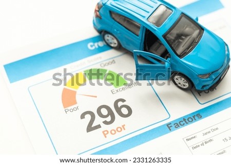 Credit Report text on paper sheet with magnifying glass on chart, dice, spectacles, pen, laptop and blue and yellow push pin on wooden table - business, banking, finance and investment concept Royalty-Free Stock Photo #2331263335