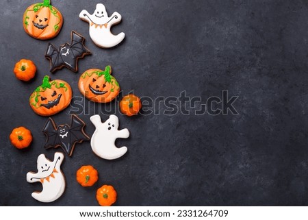 Halloween greeting card with copy space. Set of Halloween gingerbread cookies on dark stone background