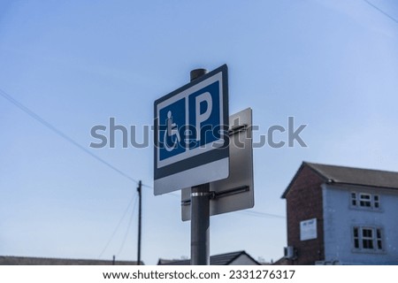 Accessible parking sign against the clear blue sky background, disability and travel concept illustration.