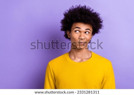 Photo of positive minded creative man look interested empty space contemplate isolated on violet color background