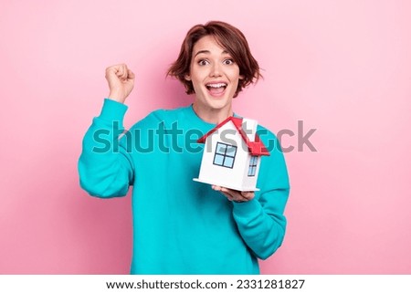 Portrait of cheerful positive girl wear stylish cyan clothes raise hand rejoice celebrate buy new house isolated on pink color background
