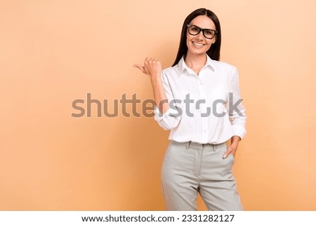 Photo of minded cheerful pretty girl crossed arms look interested empty space brainstorming isolated on beige color background
