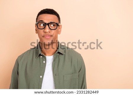Photo of minded pensive person look interested empty space contemplate hesitate isolated on beige color background