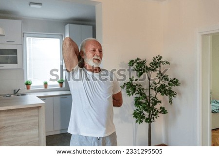 Mature adult man doing yoga at home during the outbreak.