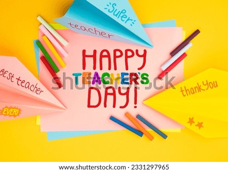 Childish lettering for Teachers' Day. Appreciation of teachers top view flat lay concept. Colored paper, multi-coloured letters, supplies for grade school.