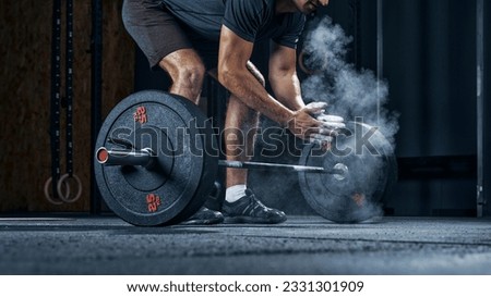 Sports equipment closeup concept. Cropped shot of male athlete preparing for workout with heavy weights clapping hands. Royalty-Free Stock Photo #2331301909