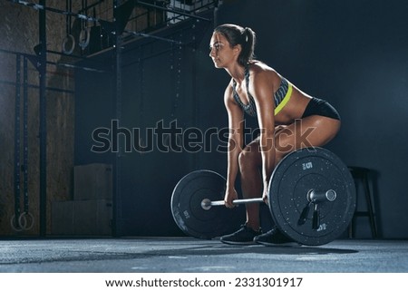 A portrait of a male weightlifter in grey sportswear. He does barbell fitness workout in the modern gym. Weightlifting, power lifting training, sports lover Royalty-Free Stock Photo #2331301917